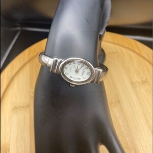 Ladies Elkon silver tone watch with spring bangle type band